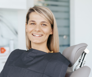 Woman Sitting in Dentist Chair Smiling