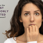 Woman holding mouth wondering what is the most commonly treated dental issue?