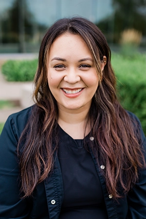 Close up a woman, Mayra, smiling. She is a Dental Assistant